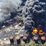 Oil storage fire. The tank farm is burning, black smoke is combu