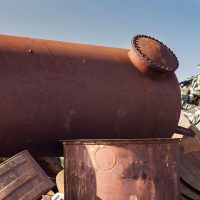 Rusty underground storage tank on junkyard